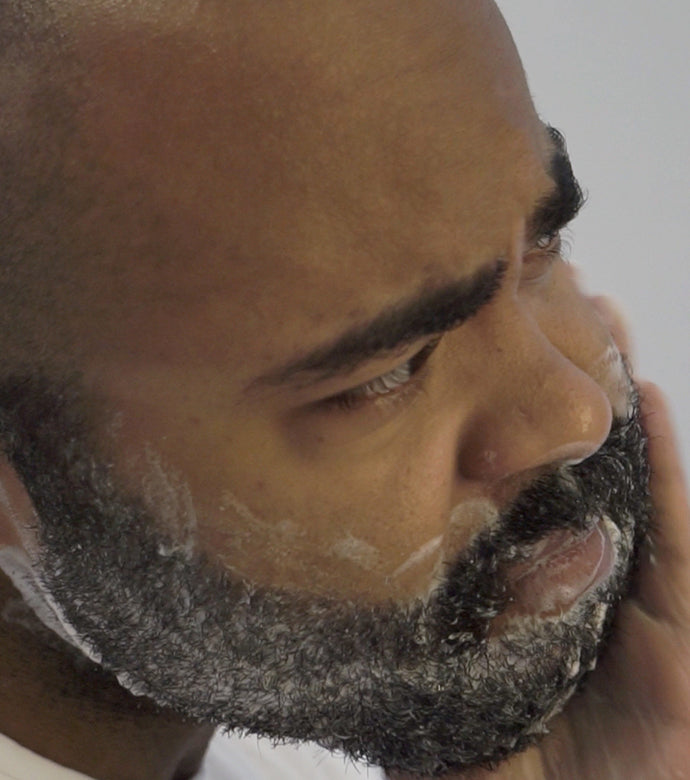 Man using Beard Wash to cleanse his beard with white background